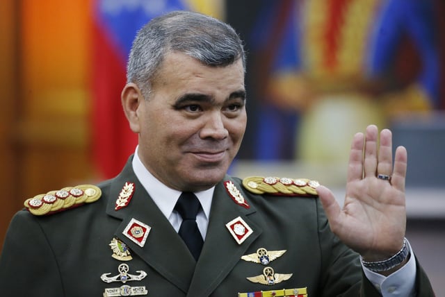 FILE - Defense Minister Vladimir Padrino Lopez waves as he arrives to a press conference by President Nicolas Maduro at Miraflores presidential palace in Caracas, Venezuela, Jan. 25, 2019. (AP Photo/Ariana Cubillos, File)