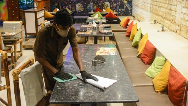 Pune, India - Oct. 3, 2020:A worker cleans a dining area of a restaurant in Baner in Pune, India, on Saturday, October 3, 2020. (Photo by Milind Saurkar/Hindustan Times) (Milind Saurkar/HT Photo)