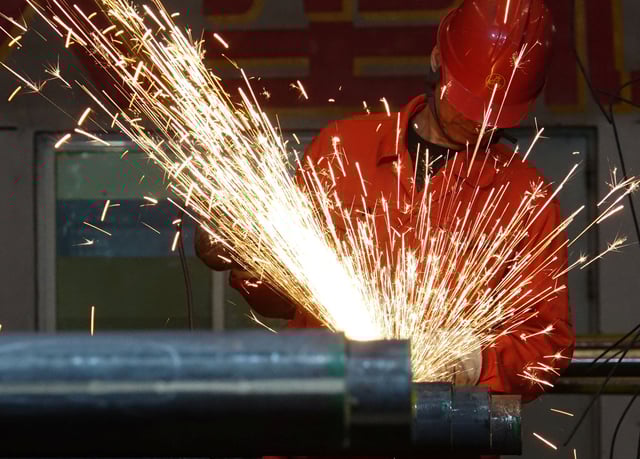 A worker polishes steel pipes at a factory of Dongbei Special Steel Group Co Ltd in Dalian, Liaoning province, China March 27, 2018. REUTERS/Stringer/ File Photo