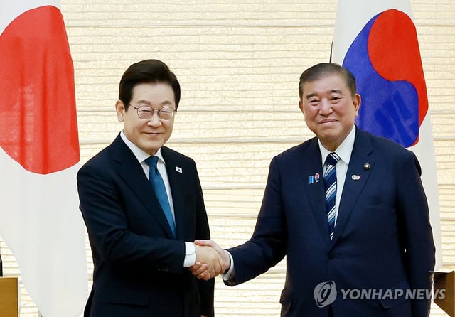 President Lee Jae Myung (L) and Japanese Prime Minister Shigeru Ishiba shake hands after holding a joint press conference following their talks at the premier's office in Tokyo on Aug. 23, 2025. (Yonhap)