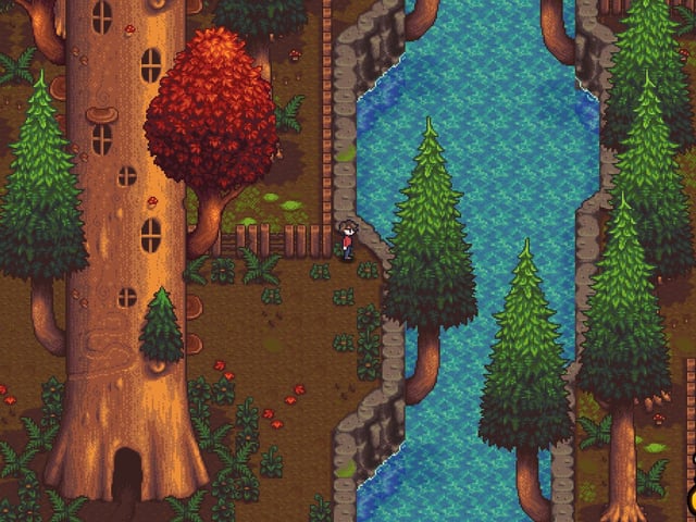 A screenshot from Haunted Chocolatier showing a small figure looking at a stream of water in an autumnal forest landscape