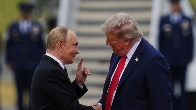 President Donald Trump greets Russia's President Vladimir Putin on the tarmac at Joint Base Elmendorf-Richardson in Anchorage, Alaska, Aug. 15, 2025. (AP Photo/Julia Demaree Nikhinson)
