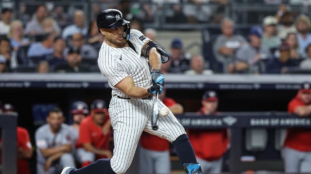 Aug 26, 2025; Bronx, New York, USA; New York Yankees right fielder Giancarlo Stanton (27) hits a three run double in the third inning against the Washington Nationals at Yankee Stadium. Mandatory Credit: Wendell Cruz-Imagn Images