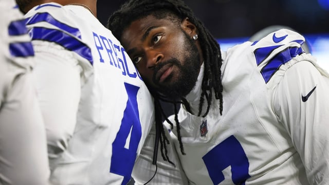 Dallas Cowboys cornerback Trevon Diggs, right, leans on quarterback Dak Prescott (4) 