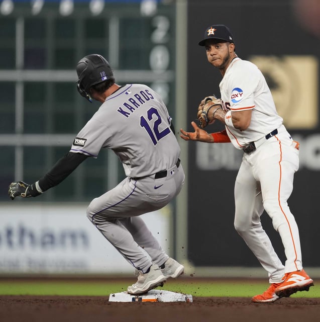 Houston Astros shortstop Jeremy Peña (3) mishandles an exchange from his glove allowing Colorado Rockies Kyle Karros to reach second during the third inning of an MLB baseball game in Houston, Tuesday, Aug. 26, 2025. Peña was charged with an error on the play.