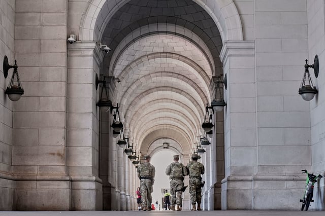Armed members of the National Guard patrol Union Station, in Washington, DC on Tuesday.