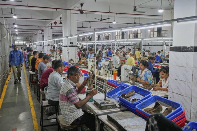 Workers in a manufacturing unit make leather footwear in Agra, India, Monday, Aug. 25, 2025. (AP Photo/Manish Swarup)