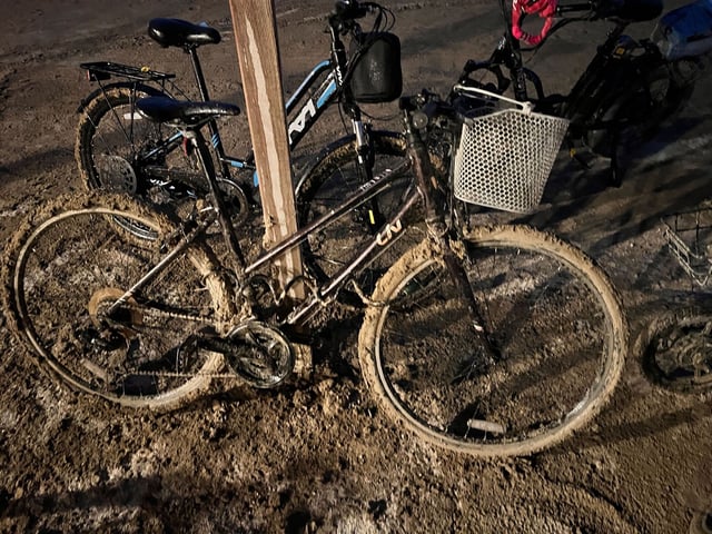 Reporter Timothy Karoff's gear became caked with mud as rain descended on Burning Man on Sunday night.