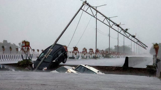 Vehicles plunge as a portion of the Fourth Tawi Bridge collapses at Bhagwati Nagar in Jammu on Tuesday.