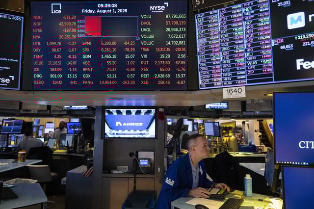 A screen shows stock prices on the floor of the New York Stock Exchange, Friday, Aug. 1, 2025, in New York. (AP Photo/Yuki Iwamura)