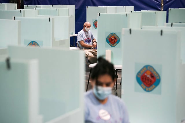 Election workers staff one of a few in-person voting places in Las Vegas during a nearly all-mail primary election, on June 9, 2020.