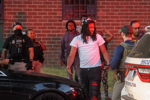 A man has his car searched by multiple federal agencies including Department of Homeland Security investigations, Bureau of Alcohol, Tobacco, Firearms and Explosives (ATF) and the Washington Metro Police Department in Washington, Monday, Aug. 25, 2025. (AP Photo/Rod Lamkey, Jr.)
