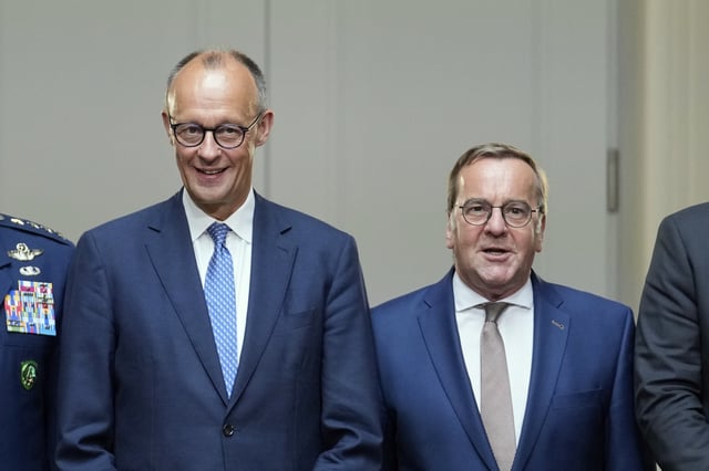 German Chancellor Friedrich Merz, left, and German Defense Minister Boris Pistorius pose for a group picture prior to the Cabinet meeting at the Defense Ministry in Berlin, Germany, Wednesday, Aug. 27, 2025. (AP Photo/Ebrahim Noroozi)
