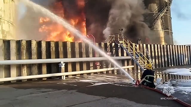 In this photo taken from video released by Russian Emergency Ministry Press Service on Tuesday, June 18, 2024, firefighters work at the site of an oil reservoir in Azov district of Rostov-on-Don region of Russia.