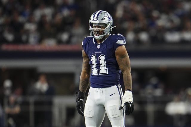 Micah Parsons #11 of the Dallas Cowboys looks on from the field during an NFL football game against the Detroit Lions at AT&T Stadium on December 30, 2023 in Arlington, Texas.