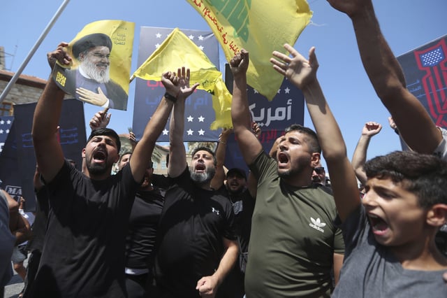Hezbollah supporters shout slogans during a protest against Tom Barrack, U.S. President Donald Trump's envoy to the Middle East, who was supposed to visit Tyre city in south Lebanon, Wednesday, Aug. 27, 2025.