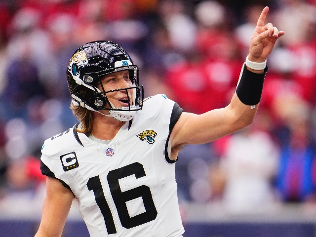 HOUSTON, TX - NOVEMBER 26: Trevor Lawrence #16 of the Jacksonville Jaguars celebrates after scoring a touchdown against the Houston Texans during the first half at NRG Stadium on November 26, 2023 in Houston, Texas. (Photo by Cooper Neill/Getty Images)