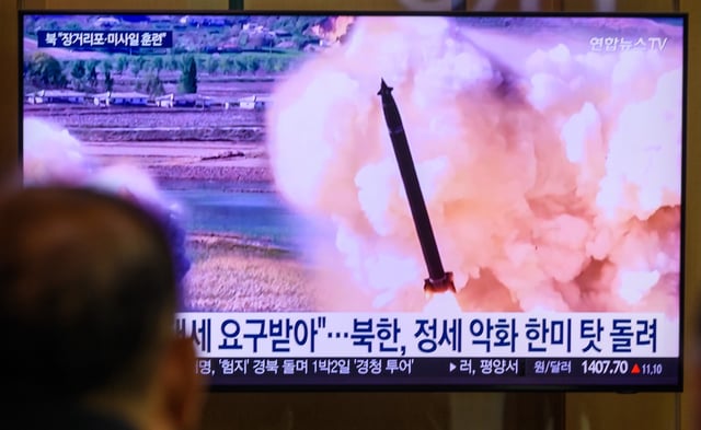 SEOUL, SOUTH KOREA - 2025/05/09: People watch a 24-hour Yonhap News TV broadcast on a large screen at Seoul Railway Station, showing footage of a joint striking drill involving long-range artillery and missile systems conducted by the Korean People's Army eastern front division at an undisclosed location in North Korea. North Korean leader Kim Jong Un oversaw a joint striking drill involving long-range artillery and a new variant of tactical ballistic missiles, reaffirming the combat readiness of the country’s nuclear forces, state media KCNA reported on May 9. The exercise featured a 600mm multiple rocket launcher and the Hwasongpho-11-Ka tactical ballistic missile. South Korea’s military detected multiple short-range ballistic missile launches from Wonsan between 8:10 and 9:20 a.m. on May 8—North Korea’s fourth missile test of the year. (Photo by Kim Jae-Hwan/SOPA Images/LightRocket via Getty Images)