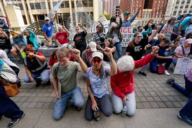 Demonstrators raise their fists on the day Kilmar Abrego, a migrant whose wrongful deportation to El Salvador made him a symbol of U.S. President Donald Trump's aggressive immigration policies, appears at the ICE Baltimore field office for a check-in three days after his release from criminal custody in Tennessee, in Baltimore, Maryland, U.S. August 25, 2025.  REUTERS/Elizabeth Frantz