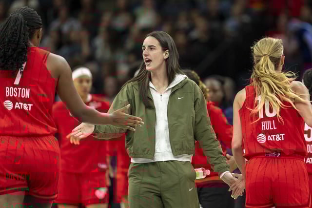 Aug 24, 2025; Minneapolis, Minnesota, USA; Indiana Fever guard Caitlin Clark (22) shakes hands with Indiana Fever forward Aliyah Boston (7) and Indiana Fever guard Lexie Hull (10) during a timeout against the Minnesota Lynx in the first half at Target Center. Mandatory Credit: Jesse Johnson-Imagn Images/File Photo