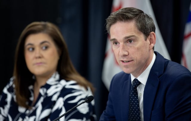 Newfoundland and Labrador Premier John Hogan, right, speaks, as Krista Lynn Howell, Minister of Health and Community Services looks on, at an update on the wildfire situation, in St. John's, N.L., on Thursday, Aug. 14, 2025. THE CANADIAN PRESS/Paul Daly