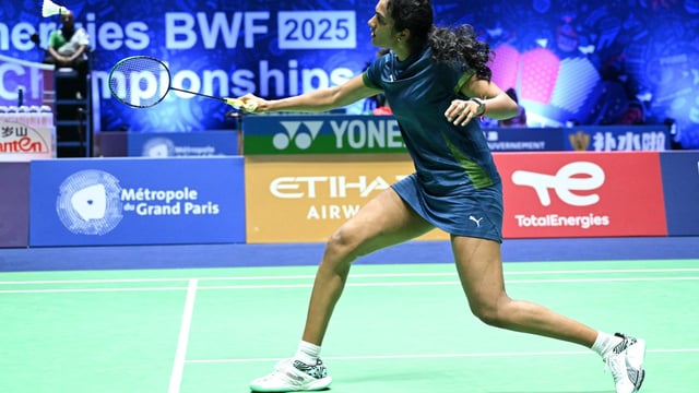 India's V. Sindhu Pusarla hits a return to Malaysia's Karupathevan Letshanaa (unseen) during their women's single match at the Badminton BWF World Championships
