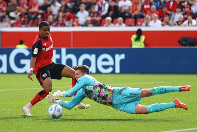 Soccer Football - Bundesliga - Bayer Leverkusen v FC Augsburg - BayArena, Leverkusen, Germany - April 26, 2025 Bayer Leverkusen's Amine Adli in action with FC Augsburg's Finn Dahmen REUTERS/Thilo Schmuelgen/File Photo