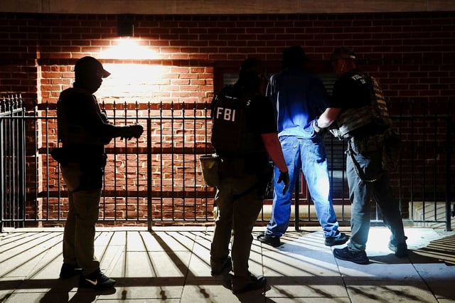 Members of the US Secret Service and FBI detain a man outside the New York Avenue Presbyterian Church in Washington, DC, on August 14, 2025.
