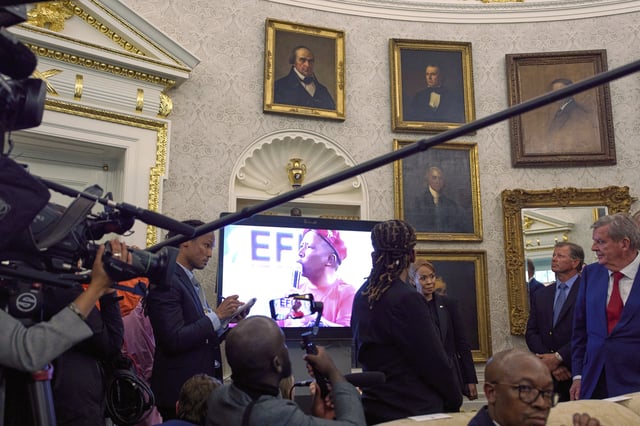 FILE - A video plays during a meeting between President Donald Trump and South Africa's President Cyril Ramaphosa in the Oval Office of the White House, May 21, 2025, in Washington. (AP Photo/Evan Vucci, File)