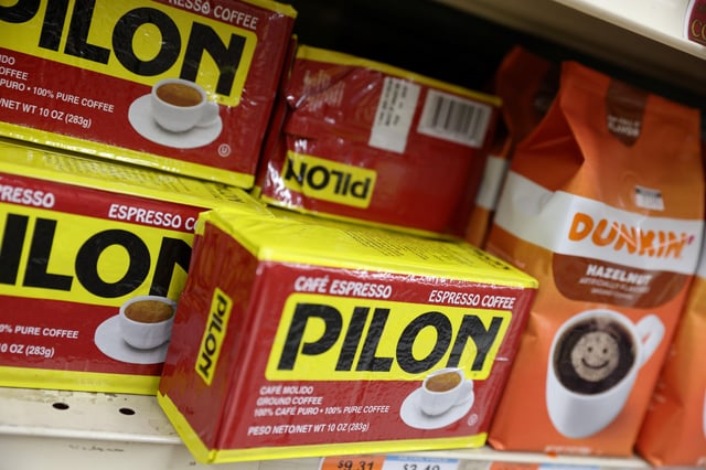 Packs of Pilon and Dunkin' coffee, brands owned by The J.M. Smucker Company, are seen for sale in a store in Manhattan, New York City, U.S., November 22, 2021. REUTERS/Andrew Kelly/File Photo