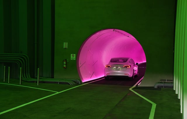A Tesla car drives through a tunnel in the Central Station during a media preview of the Las Vegas Convention Center Loop on April 9, 2021 in Las Vegas, Nevada.