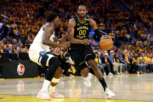Jonathan Kuminga #00 of the Golden State Warriors dribbles the ball against Anthony Edwards #5 of the Minnesota Timberwolves during the third quarter in Game Four of the Western Conference Second Round NBA Playoffs at Chase Center on May 12, 2025 in San Francisco, California.