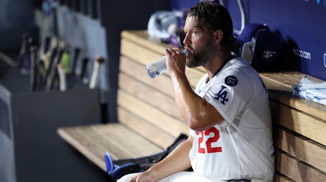 Aug 26, 2025; Los Angeles, California, USA; Los Angeles Dodgers starting pitcher Clayton Kershaw (22) drinks water in the dugout during the fourth inning against the Cincinnati Reds at Dodger Stadium. Mandatory Credit: Kiyoshi Mio-Imagn Images