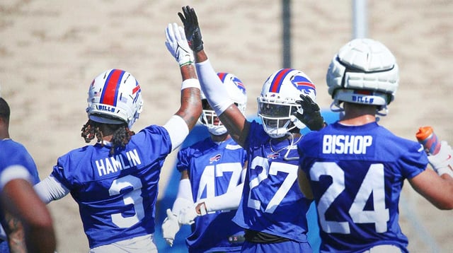 Bills defensive back Tre’Davious White high-fives Damar Hamlin as the unit starts a new set of drills during the opening day of Buffalo Bills training camp at St. John Fisher University Wednesday, July 23, 2025 in Pittsford.
