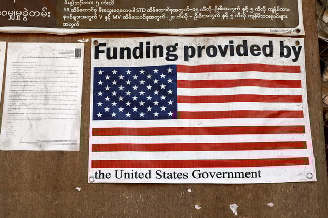 A poster is displayed inside a food distribution building at the Umpiem Mai Refugee Camp following a halt in U.S. foreign aid that led to the closure of health services inside Mae La refugee camp nearby on the Thai-Myanmar border at Phop Phra district, Tak Province, a Thai-Myanmar border province, February 7, 2025.