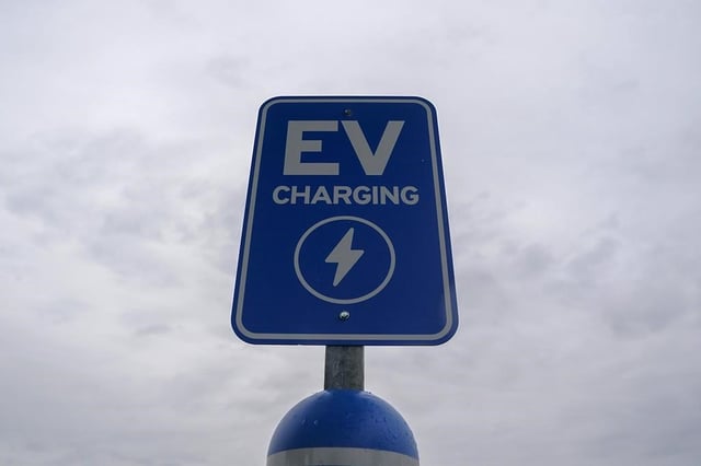 FILE - A sign is displayed at an electric vehicle charging station, March 8, 2024, in London, Ohio.