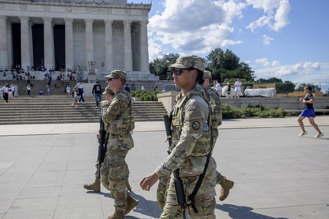Armed members of the West Virginia National Guard patrol around the Lincoln Memorial in Washington, Tuesday, Aug. 26, 2025. (AP Photo/Rod Lamkey, Jr.)