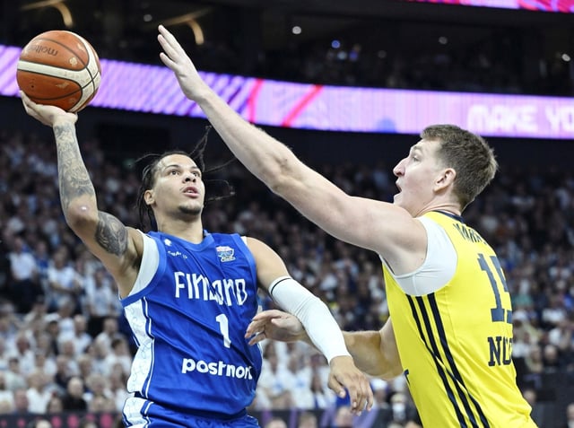 Finland's Miro Little, left, and Sweden's Mattias Markusson during the basketball FIBA EuroBasket 2025 group B match between Sweden and Finland in Tampere, Finland, Wednesday Aug. 27, 2025. (Heikki Saukkomaa/Lehtikuva via AP)