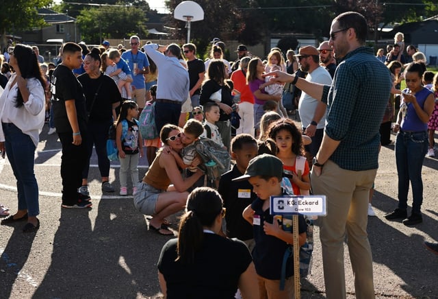 Students line up outside on the first day of the 2025–26 academic year at Columbine Elementary School in Denver, on Aug. 18, 2025. Family members say their goodbyes before the students head into school to begin the day. (Photo by RJ Sangosti/The Denver Post)