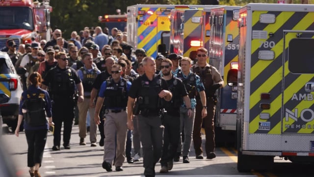 Law enforcement officers gather outside the Annunciation Church’s school