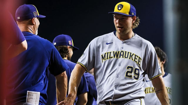 Aug 15, 2025; Cincinnati, Ohio, USA; Milwaukee Brewers relief pitcher Trevor Megill (29) high fives teammates after the victory over the Cincinnati Reds at Great American Ball Park. Mandatory Credit: Katie Stratman-Imagn Images