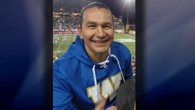Premier Wab Kinew, seen here at the 2023 Grey Cup in a photo taken with another elected official, took the Winnipeg Blue Bombers' charter to the Grey Cup that year and in 2024.  Manitoba's ethics commissioner said in a report that because Kinew paid fair market value for the charter flights he took to the Grey Cup, he wasn't required to get approval or file information about them after.