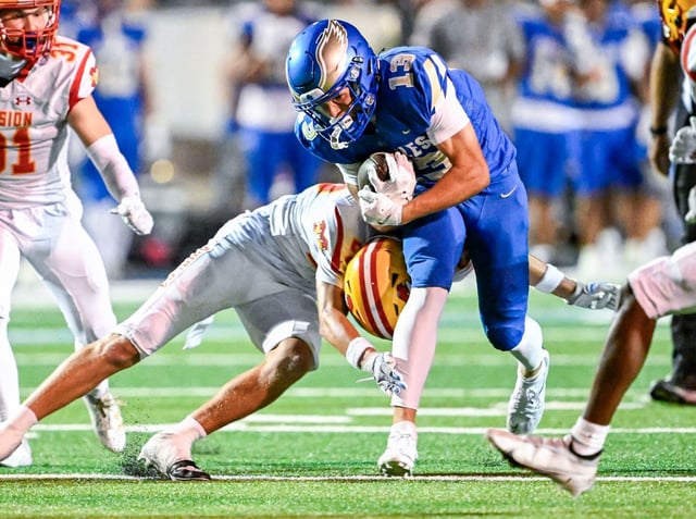 Jake Martin (13) of Santa Margarita breaks a tackle by Sawyer Thomson (23) of Mission Viejo to get to the 20 yard line with 31-seconds left in the first half of the season-opening game at Trabuco Hills High School in Mission Viejo on Friday, Aug. 22, 2025. (Photo by Leonard Ortiz, Orange County Register/SCNG)