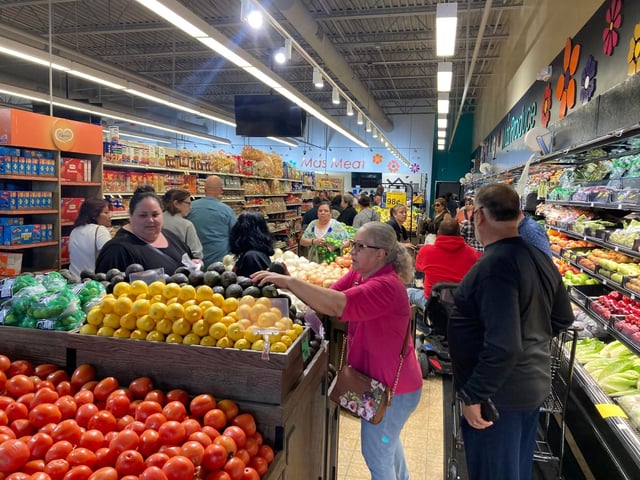 People shop Wednesday after the ribbon-cutting at El Paso Mas Grande on Aurora's far West Side. Steve Lord photo