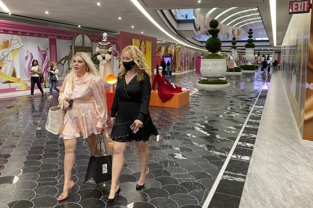 FILE - People walk through the luxury wing at the American Dream shopping mall in East Rutherford, N.J., Sept. 17, 2021. (AP Photo/Ted Shaffrey, file)