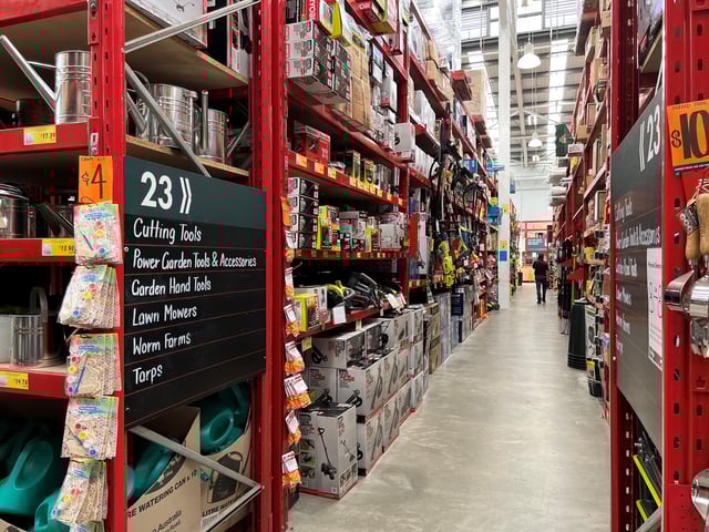 An employee of Bunnings, which is part of the Wesfarmers retail conglomerate, walks down an aisle at a store in Sydney, Australia February 17, 2022. REUTERS/Stephen Coates/File Photo