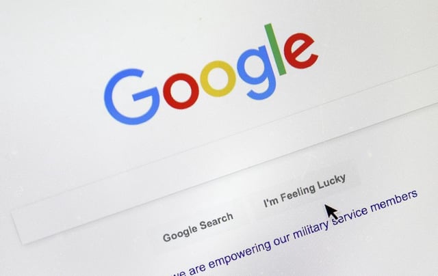 FILE - A cursor moves over Google's search engine page, in Portland, Ore., on Aug. 28, 2018. (AP Photo/Don Ryan, File)