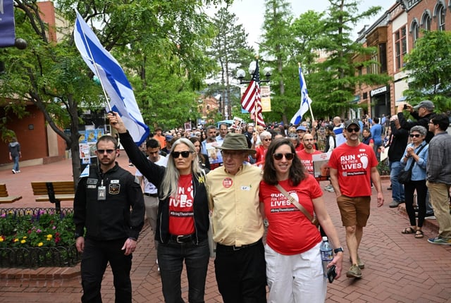 Rachel Amaru, holding Israeli flag, leads the weekly Run for Their Lives solidarity walk during a remembrance program at the Boulder Jewish Festival on the Pearl Street Mall in Boulder on June 8. The chapter announced on Aug. 27 that it will no longer publicly advertise its walks out of safety concerns. (Helen H. Richardson/The Denver Post)
