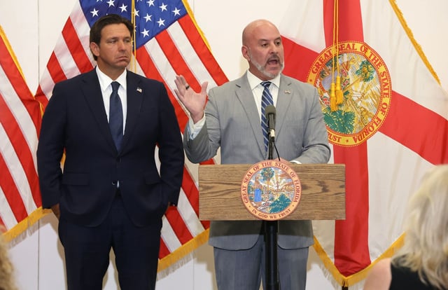 Florida CFO Blaise Ingoglia speaks as Gov. Ron DeSantis watches at left as they both announce issuing “investigative subpoenas” to Orange County employees during a press conference in Orlando on Wednesday, Aug. 27, 2025. The subpoenas are to search for information that may have been hidden or deleted by the employees during a DOGE audit. (Stephen M. Dowell/Orlando Sentinel)