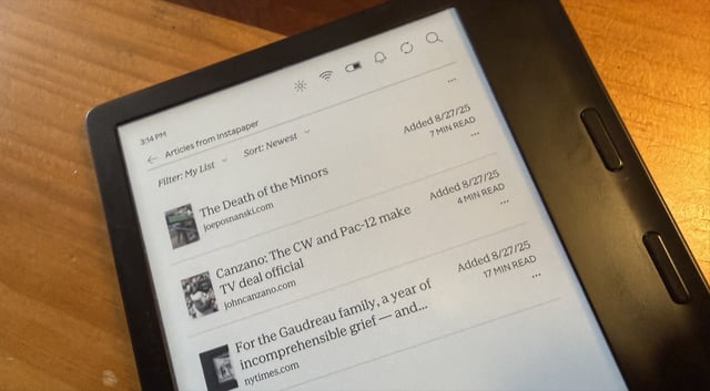 A tablet displays a list of saved articles from Instapaper. The screen shows titles like 'The Death of the Minors' and 'Canzano: The CW and Pac-12 make TV deal official,' with dates and reading times. The tablet rests on a wooden surface.